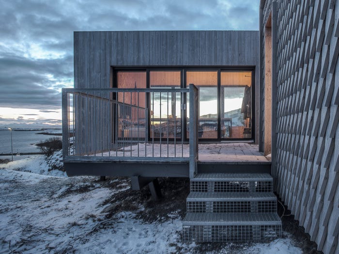 A deck attached to one of the arctic hideaway buildings