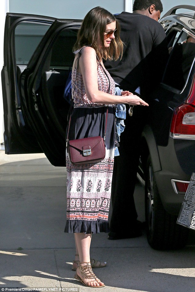 Final touches: Anne teamed the colourful garb with strappy bronze gladiator sandals and a small burgundy designer handbag