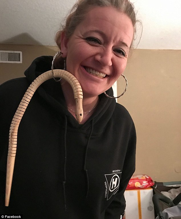 Haʋing a laugh: One of Ashley's friends (pictured) poked fun at her situation with a wooden toy snake looped through a hoop earring