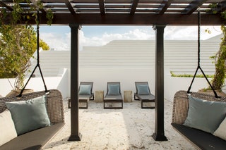 Instead of going with a white pergola this oncelonely rooftop structure provides a shady respite from the whiteonwhite...