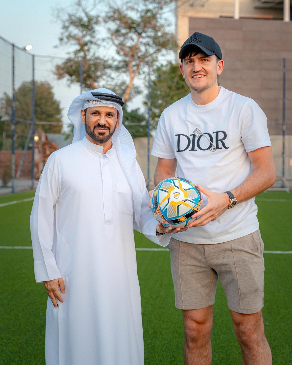 Maguire and Balhasa pose with a football